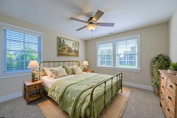 a bedroom with a bed and windows