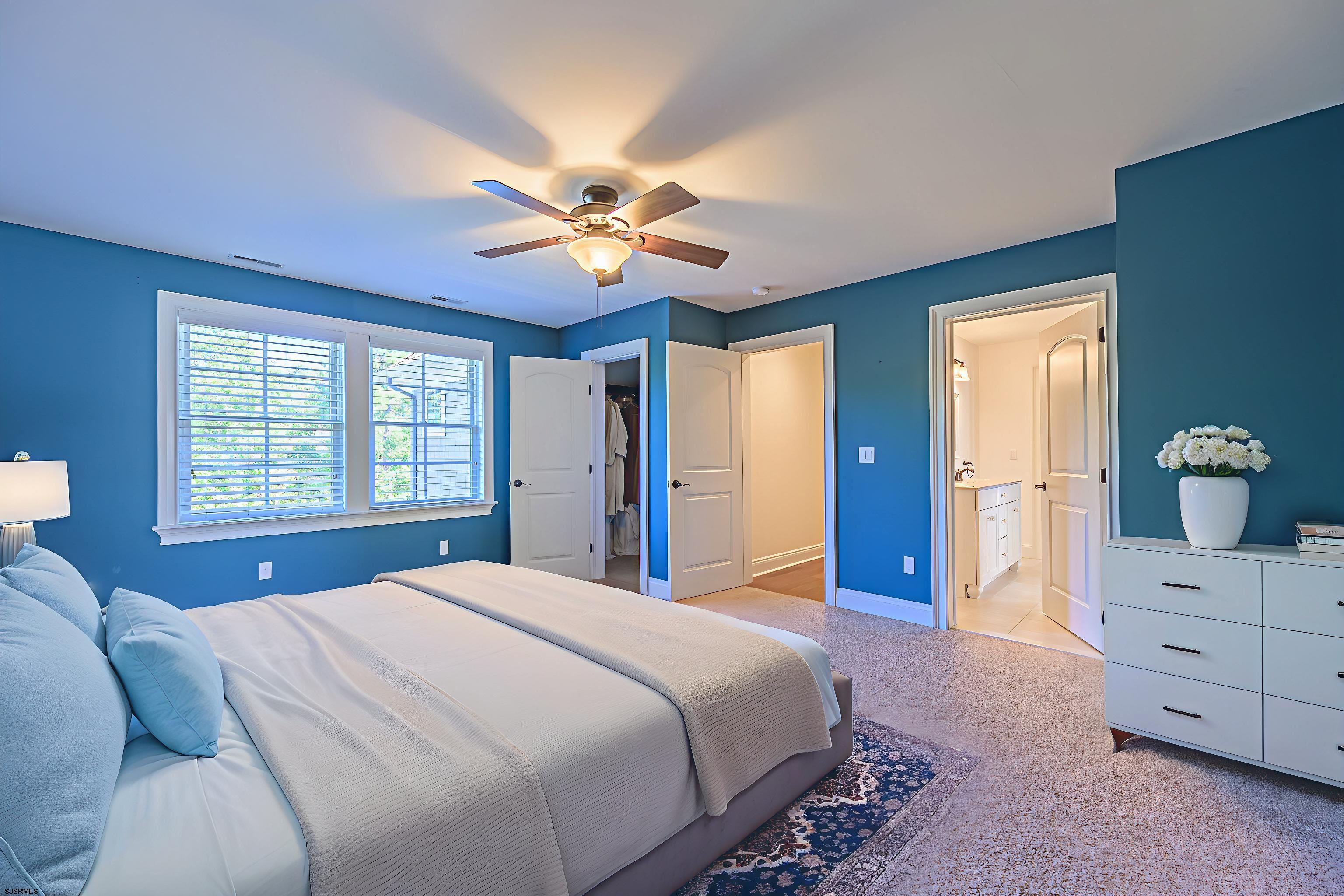 9 Thicket Street Ocean View, NJ 08230 - Photo 19 of 37 a bedroom with a bed and a chandelier