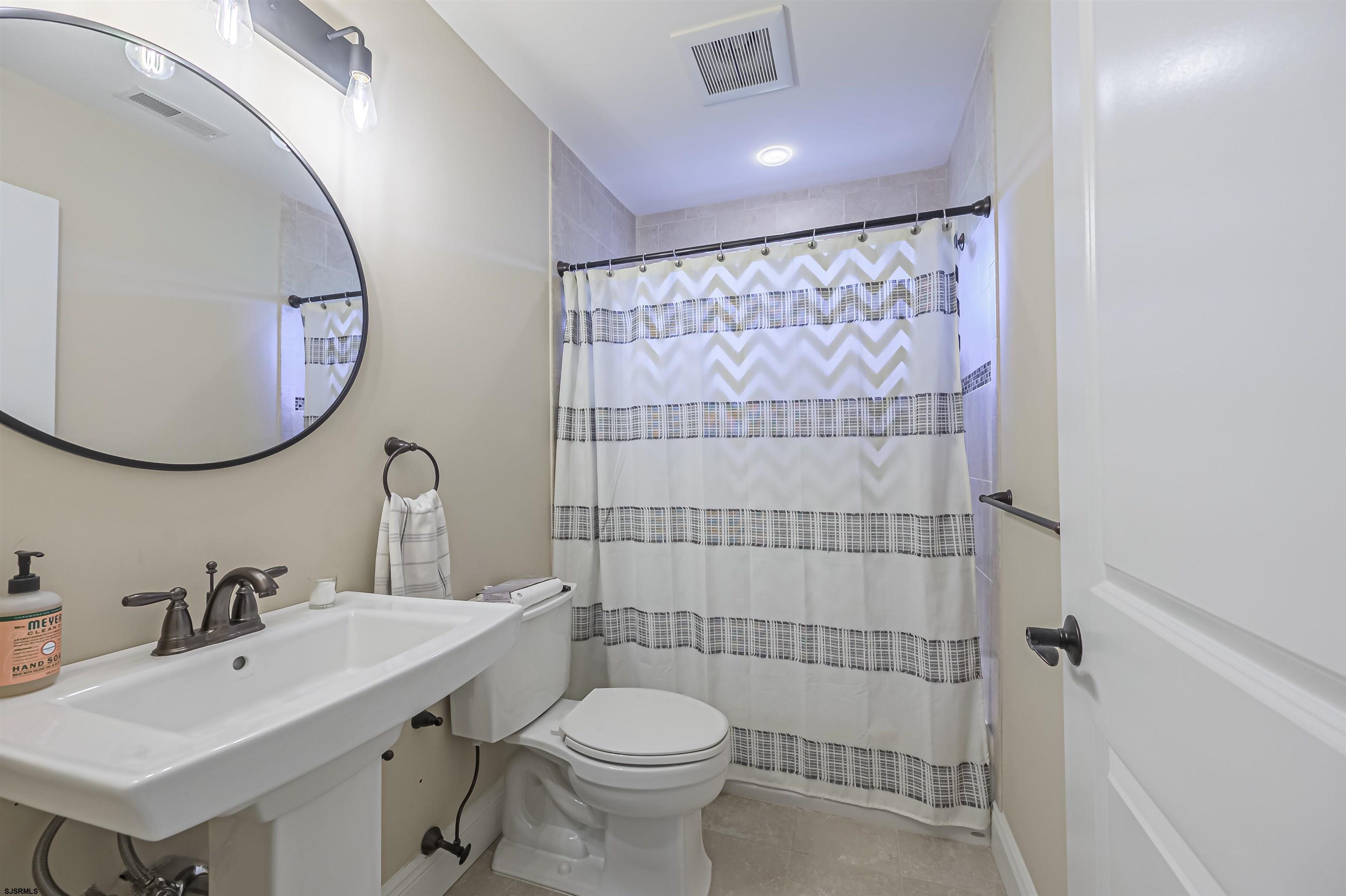 9 Thicket Street Ocean View, NJ 08230 - Photo 21 of 37 a bathroom with a sink mirror toilet and shower