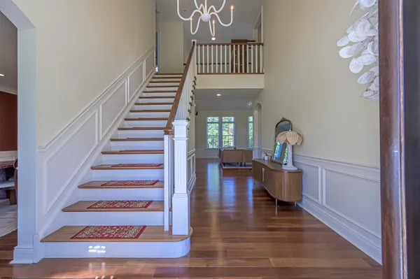 a view of entryway and hall with wooden floor