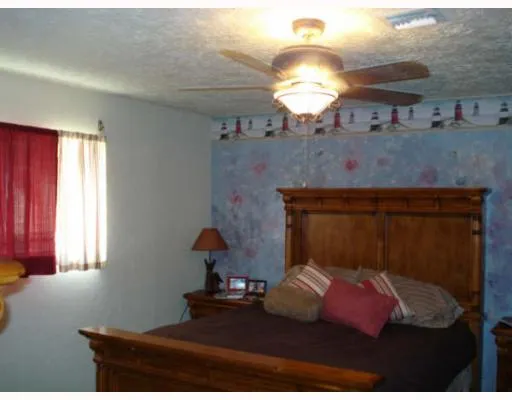 a bedroom with bed and window