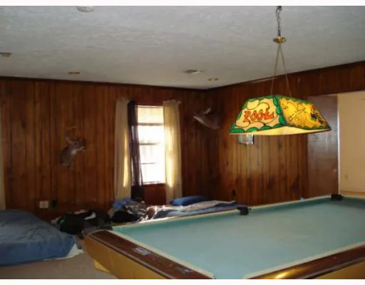 a view of a room with furniture wooden floor and windows