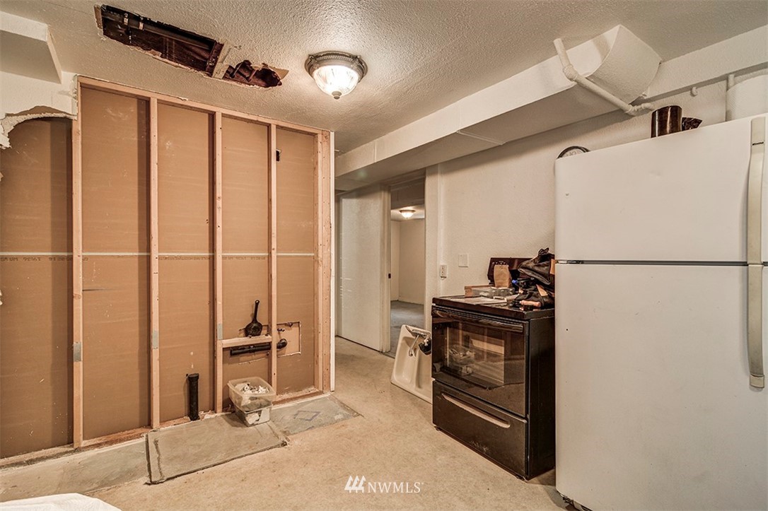 103 Logan Avenue South Renton, WA 98057 - Photo 11 of 19 a kitchen with stainless steel appliances granite countertop a refrigerator and a stove