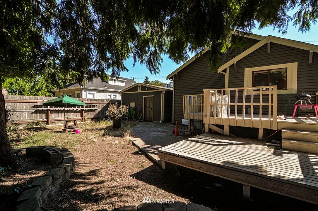 103 Logan Avenue South Renton, WA 98057 - Photo 17 of 19 a view of a house with a large window and wooden fence