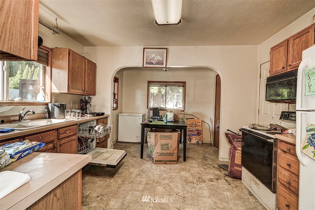 103 Logan Avenue South Renton, WA 98057 - Photo 7 of 19 a kitchen with sink cabinets and window