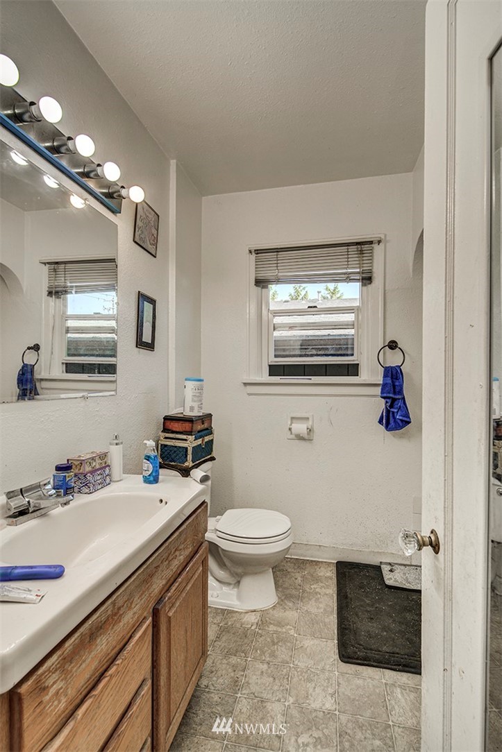 103 Logan Avenue South Renton, WA 98057 - Photo 9 of 19 a bathroom with a sink a toilet and mirror