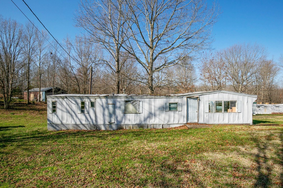 9812 Rocky Point Road Bon Aqua, TN 37025 - Photo 13 of 48 a view of a house with a yard