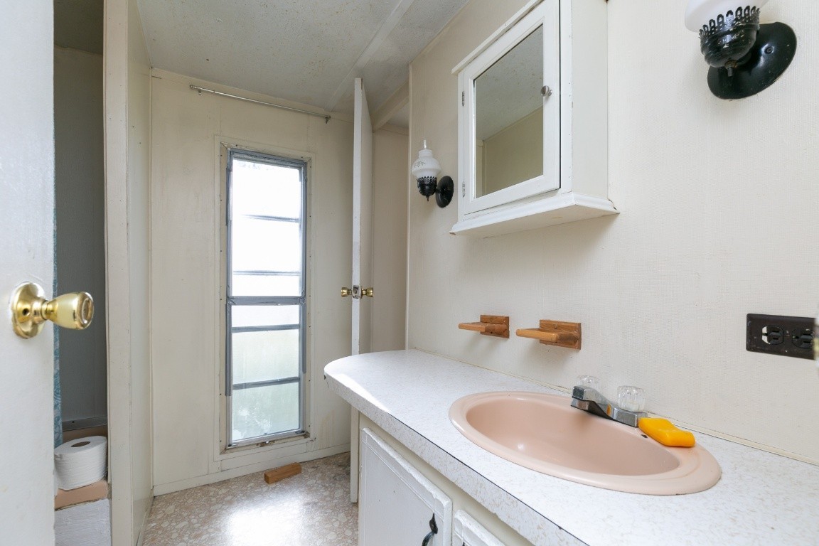 9812 Rocky Point Road Bon Aqua, TN 37025 - Photo 3 of 48 a bathroom with a sink and a mirror