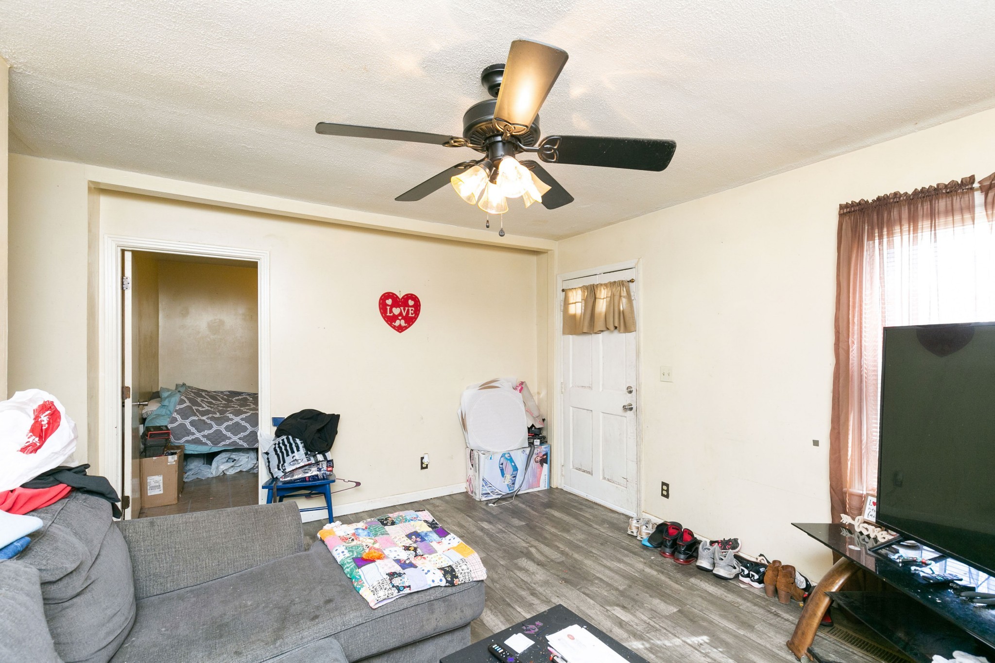 9812 Rocky Point Road Bon Aqua, TN 37025 - Photo 28 of 48 a bedroom with furniture and a chandelier fan