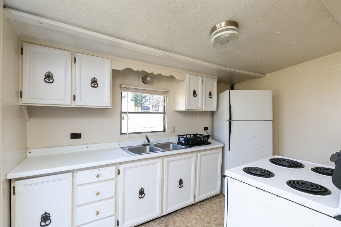 9812 Rocky Point Road Bon Aqua, TN 37025 - Photo 5 of 48 a kitchen with cabinets appliances a sink and a window