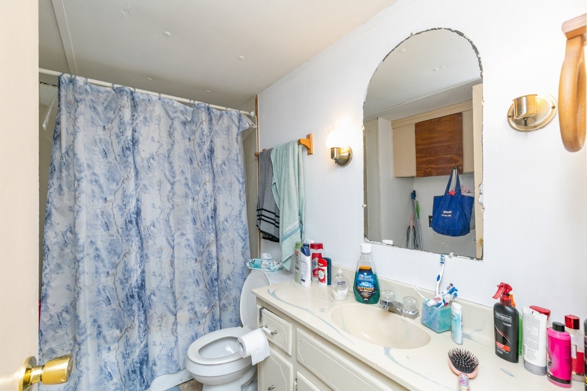 9812 Rocky Point Road Bon Aqua, TN 37025 - Photo 42 of 48 a bathroom with a sink vanity mirror and toilet
