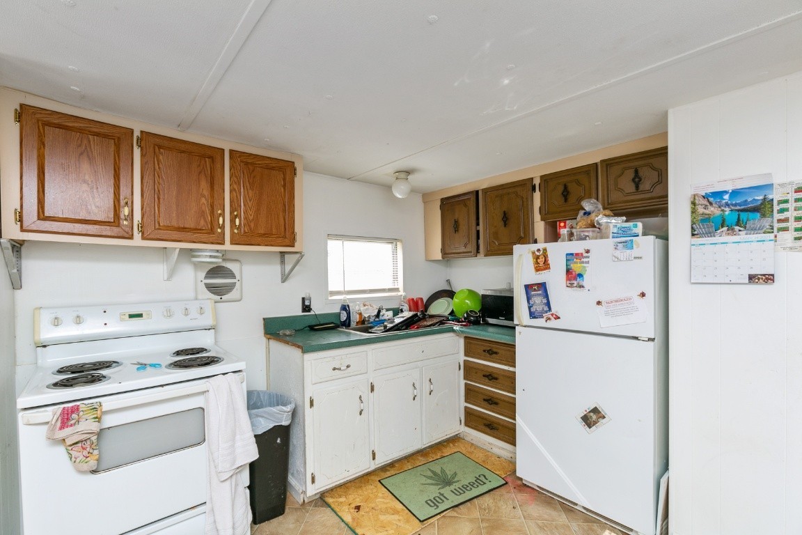 9812 Rocky Point Road Bon Aqua, TN 37025 - Photo 43 of 48 a kitchen with a white cabinets and white appliances