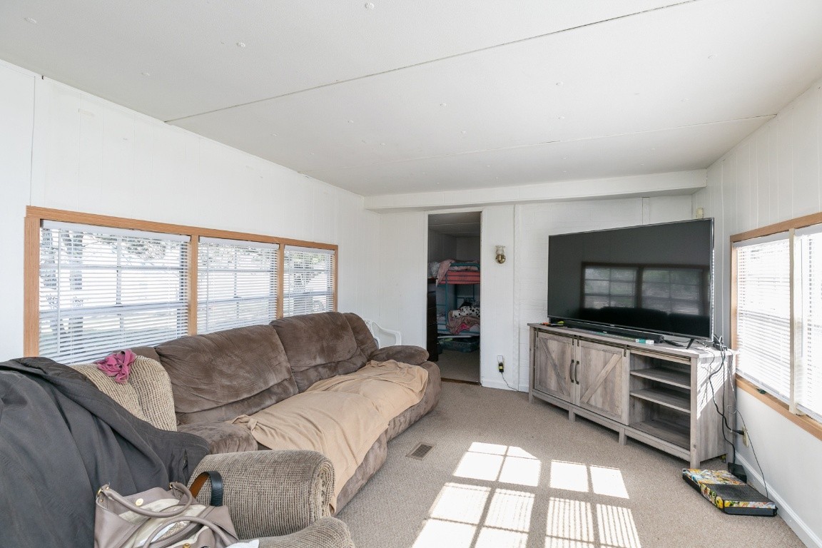 9812 Rocky Point Road Bon Aqua, TN 37025 - Photo 44 of 48 a living room with a couch and a flat screen tv