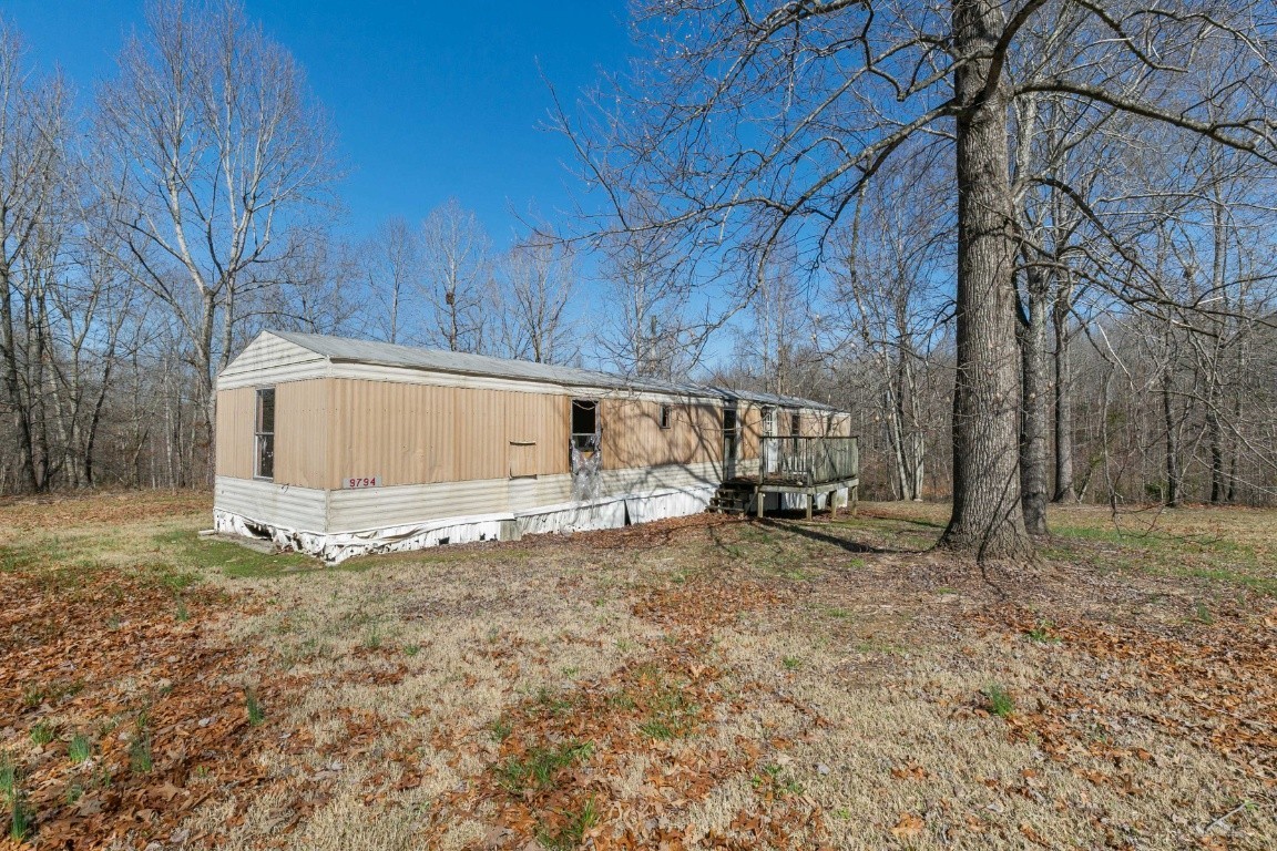 9812 Rocky Point Road Bon Aqua, TN 37025 - Photo 45 of 48 a view of a house with a yard and sitting area