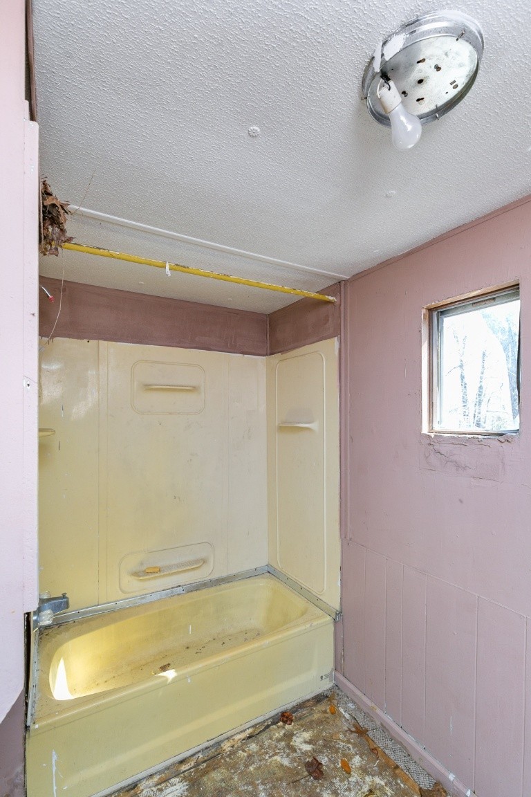 9812 Rocky Point Road Bon Aqua, TN 37025 - Photo 47 of 48 a bathroom with a tub and a shower
