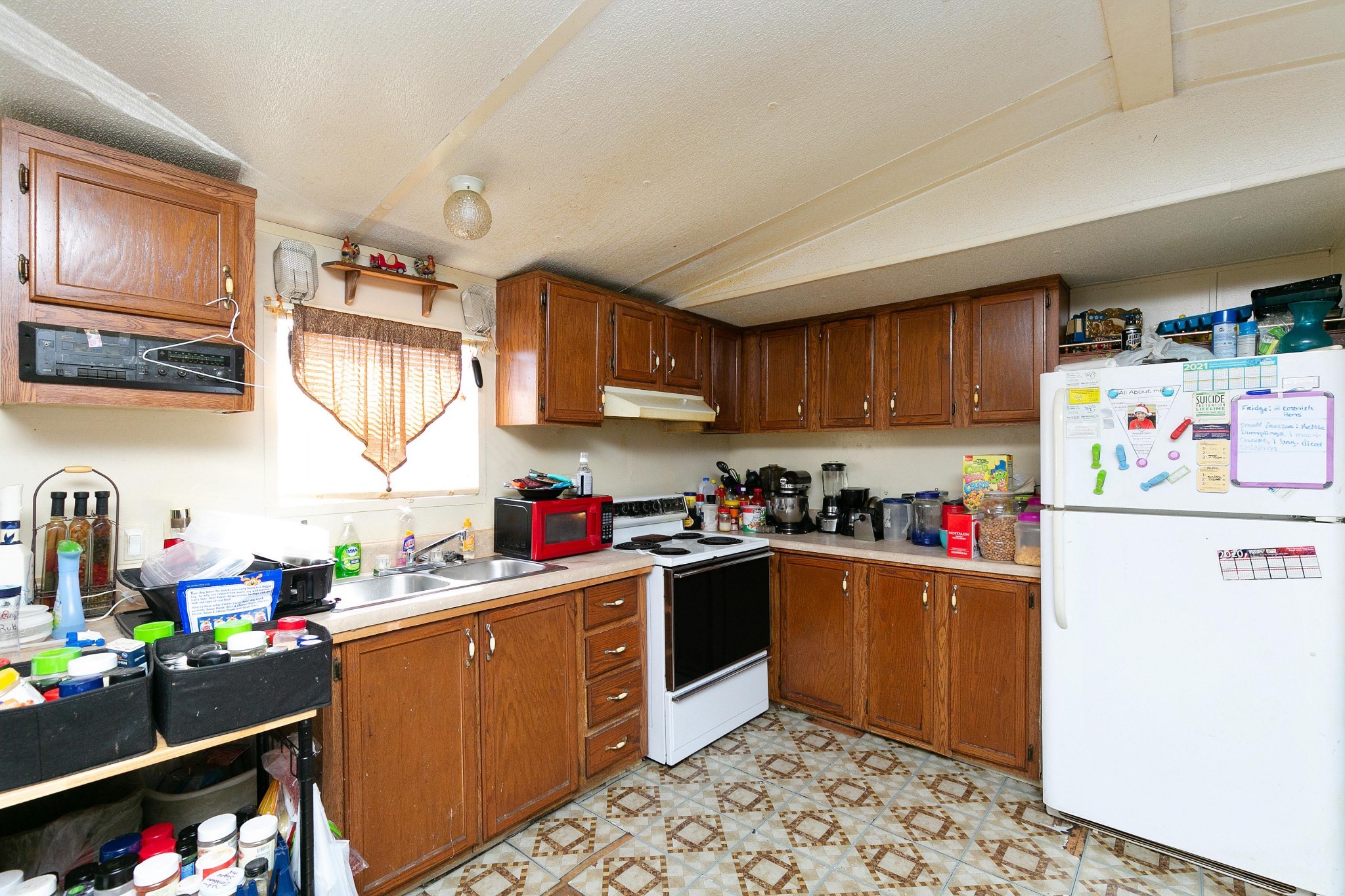 9812 Rocky Point Road Bon Aqua, TN 37025 - Photo 10 of 48 a kitchen with a refrigerator and a sink