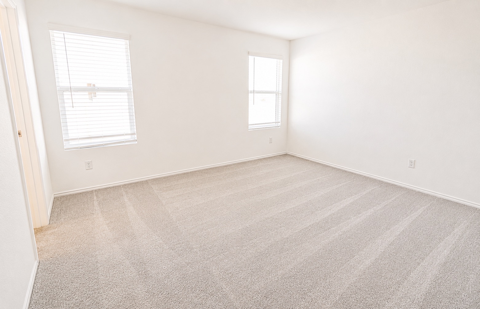 397 Keefer Kyle, TX 78640 - Photo 27 of 33 A well-lit bedroom features plush carpeting and multiple windows.