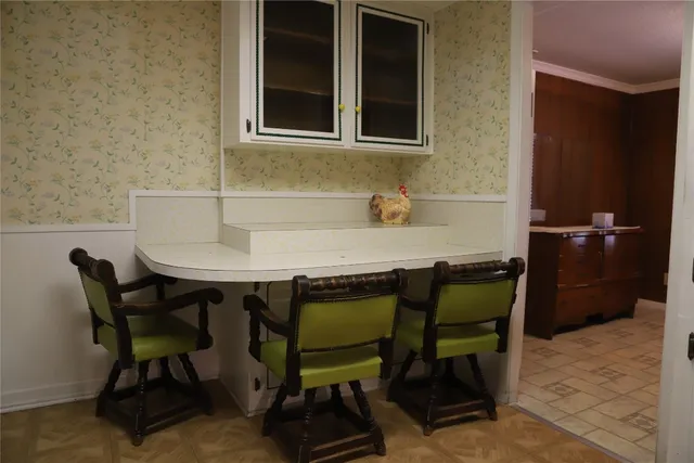 a bathroom with a granite countertop toilet sink and mirror