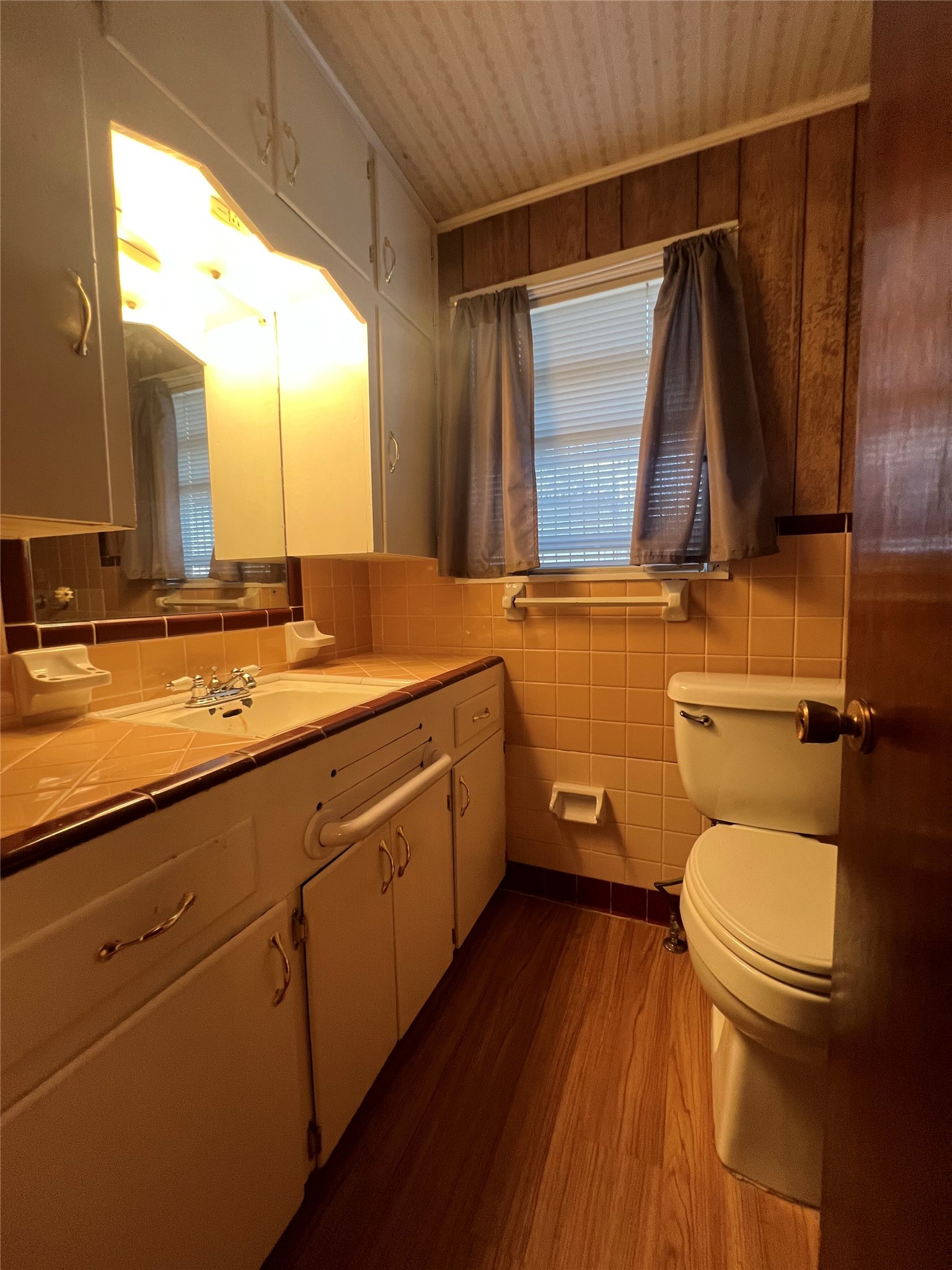 6106 Felix Avenue Austin, TX 78741 - Photo 18 of 20 a bathroom with a granite countertop toilet sink and mirror