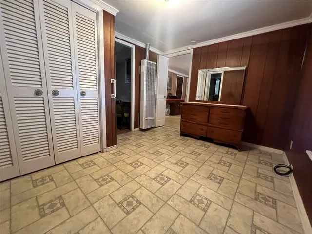 a view of an empty room with window and fire place