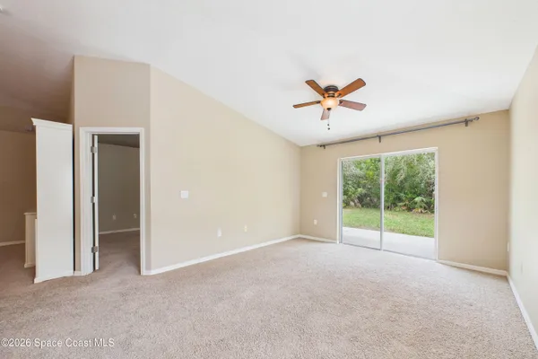 a view of a livingroom with a ceiling fan a window and a ceiling fan