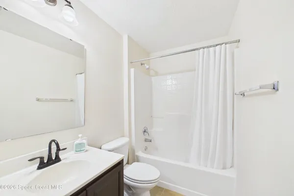 a bathroom with a sink toilet a mirror and shower