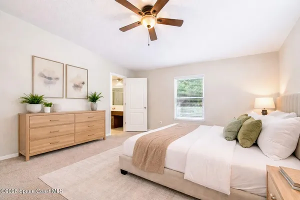 a bedroom with a bed dresser and a window