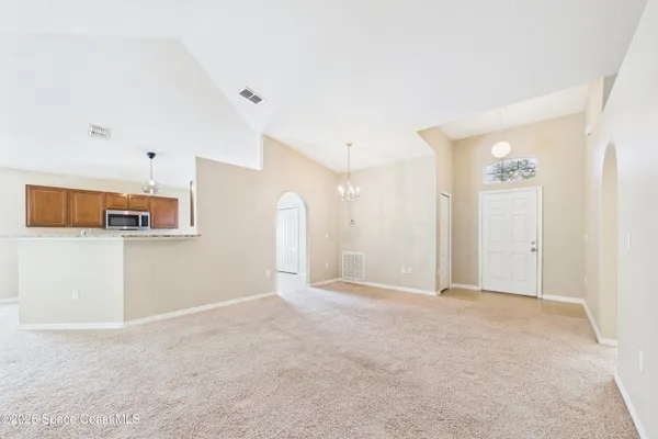 a view of a big room with closet and windows
