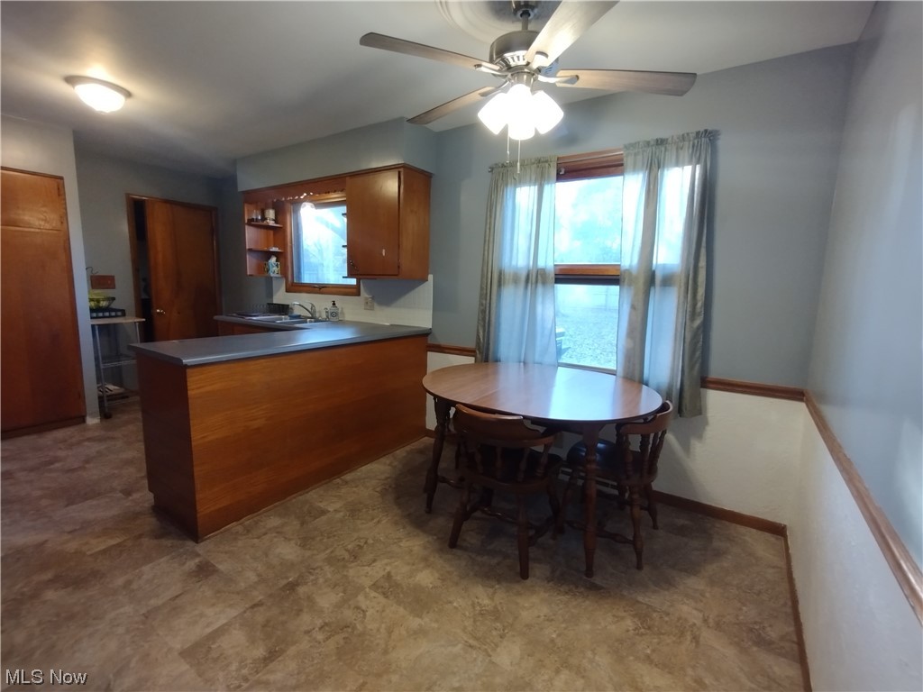 40 Taylor Road Barberton, OH 44203 - Photo 13 of 18 Kitchen featuring tile floors, ceiling fan, and kitchen peninsula