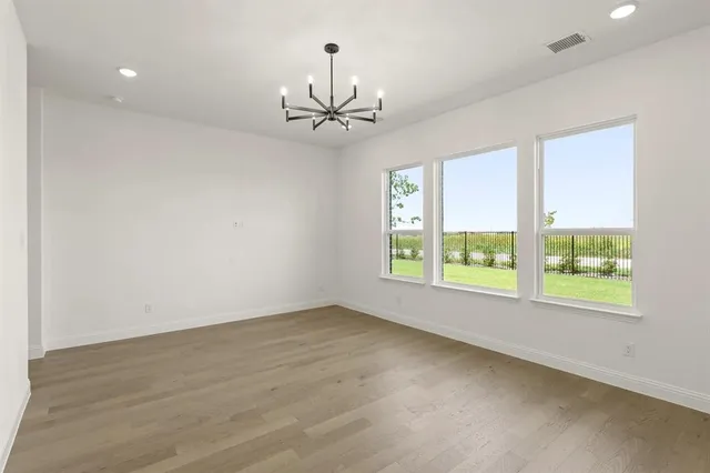 an empty room with a window and a ceiling fan
