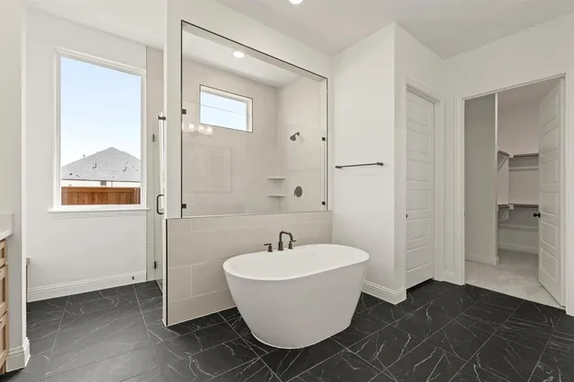 a bathroom with a bathtub and shower