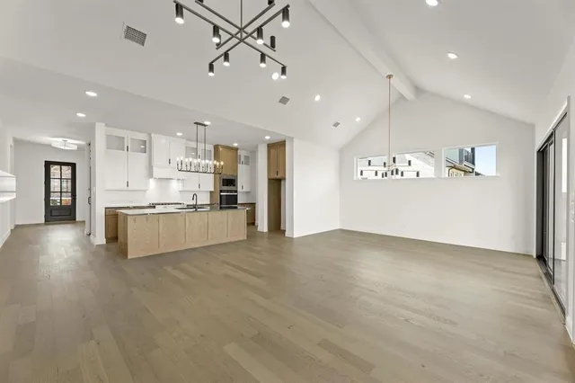 a view of kitchen with stainless steel appliances kitchen island a refrigerator and a sink