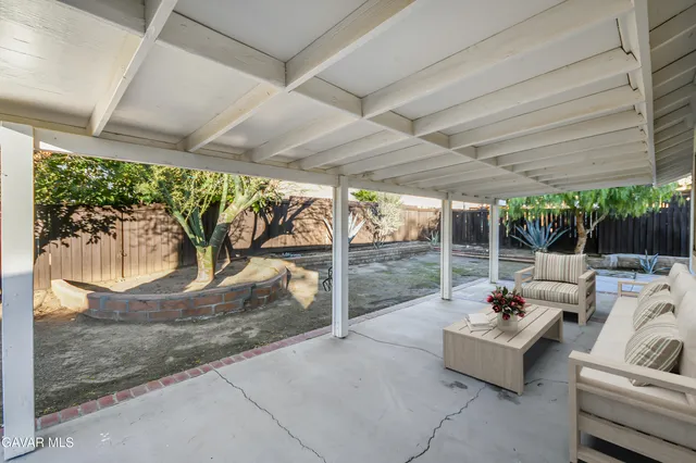 a view of a house with backyard porch and sitting area