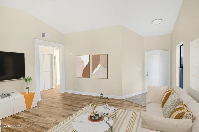 a bedroom with a bed and flat screen tv