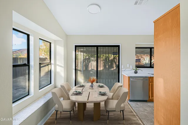 a dining room with furniture and window