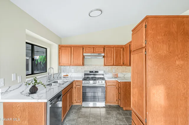 a kitchen with a sink stove and cabinets