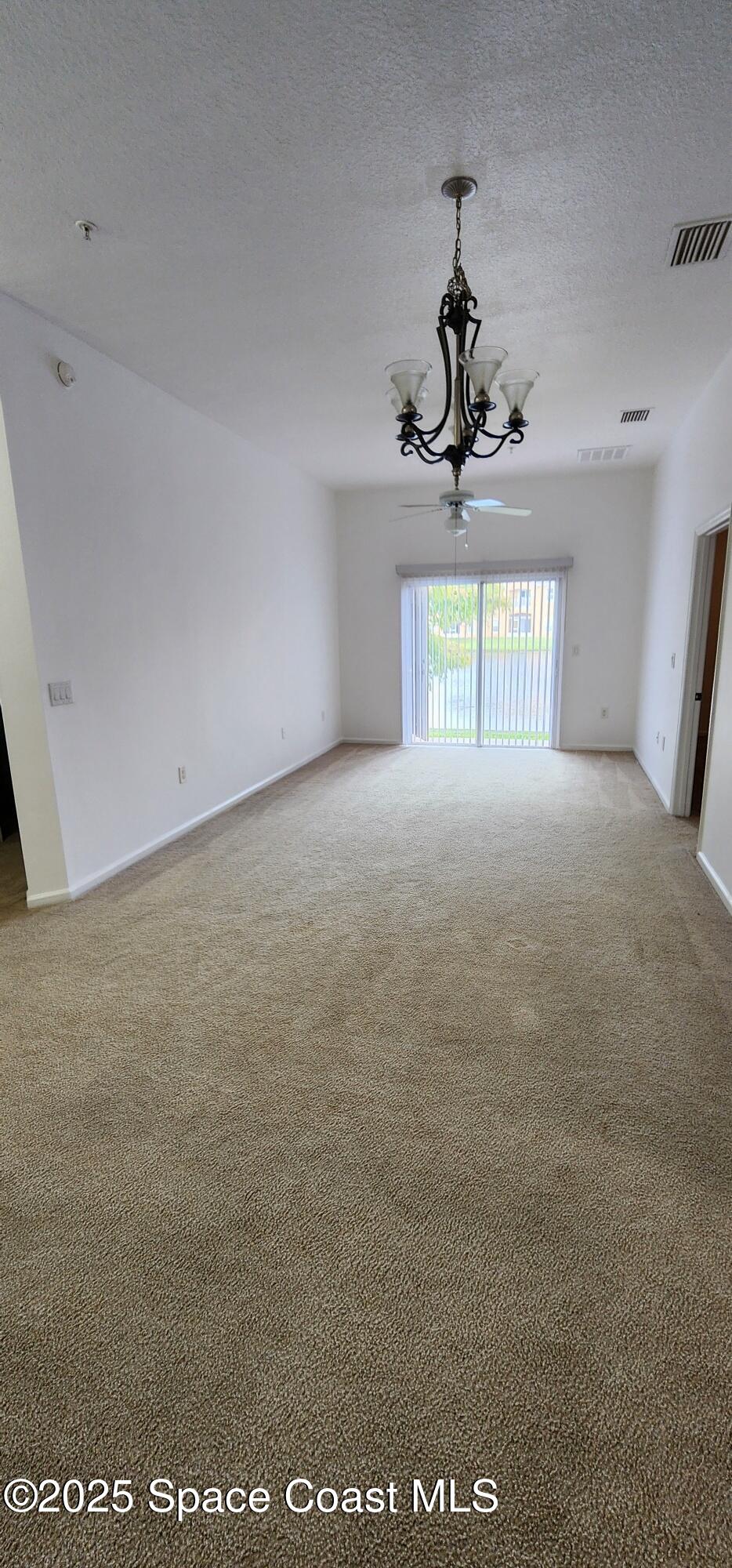4076 Meander Place, Unit 103 Rockledge, FL 32955 - Photo 12 of 24 a view of a chandelier and window in a room