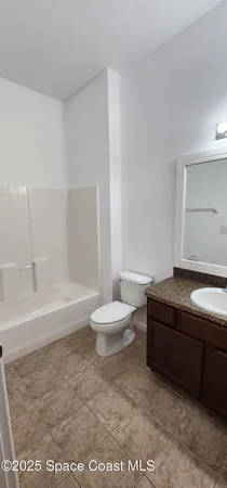 an empty room with a ceiling fan and window