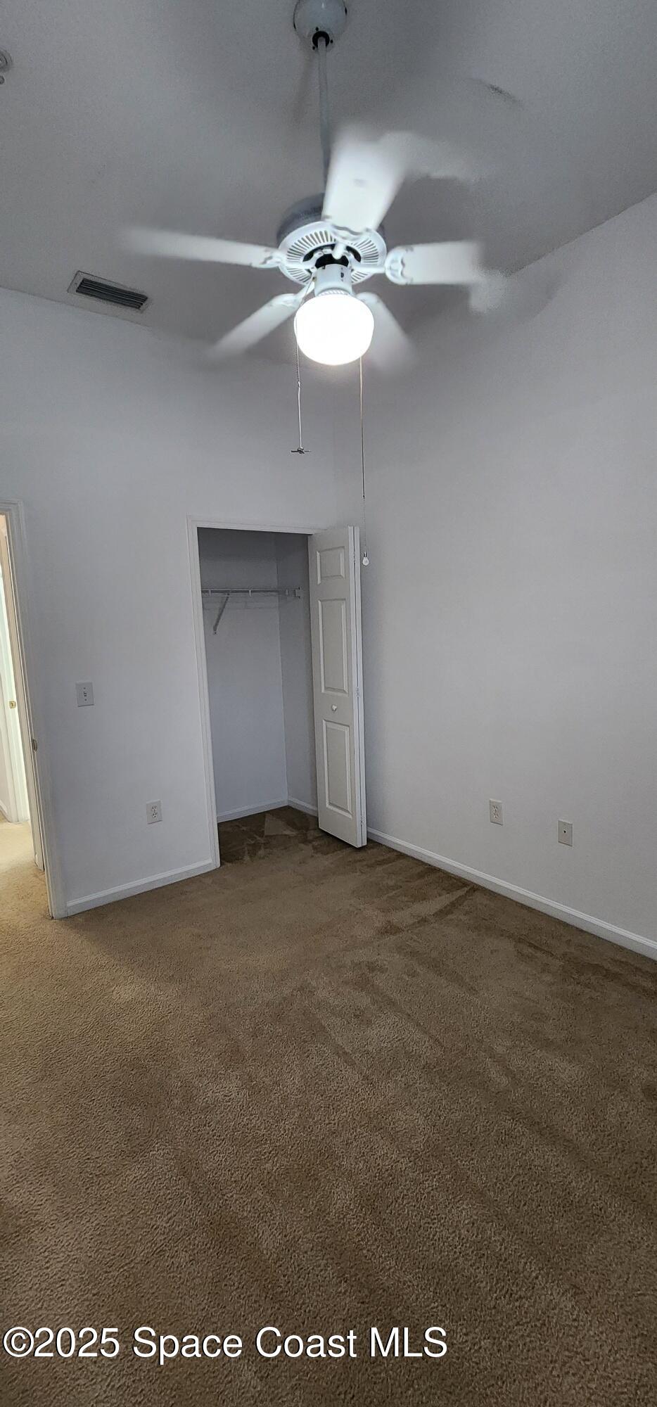 4076 Meander Place, Unit 103 Rockledge, FL 32955 - Photo 16 of 24 a view of an empty room with a chandelier fan