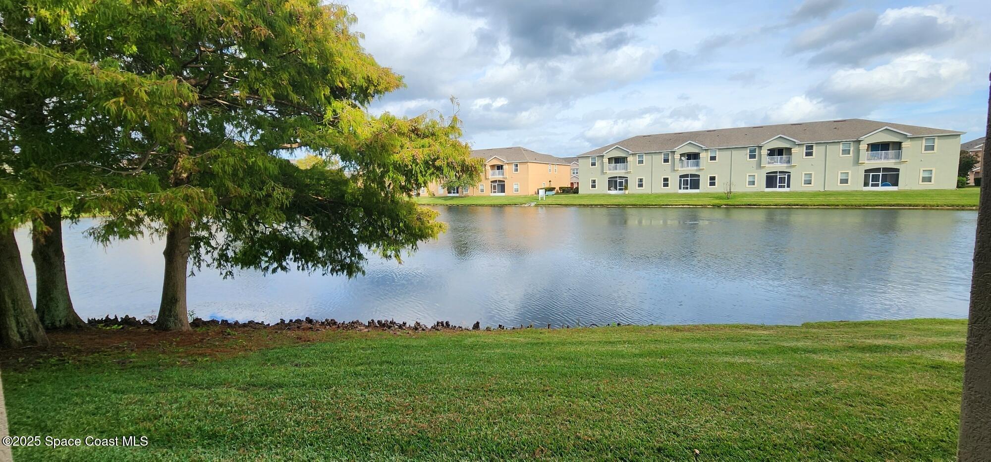 4076 Meander Place, Unit 103 Rockledge, FL 32955 - Photo 20 of 24 a view of a lake with houses in front of it