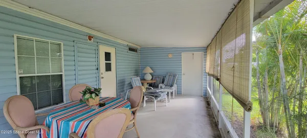 a balcony view with a potted plant and dining space