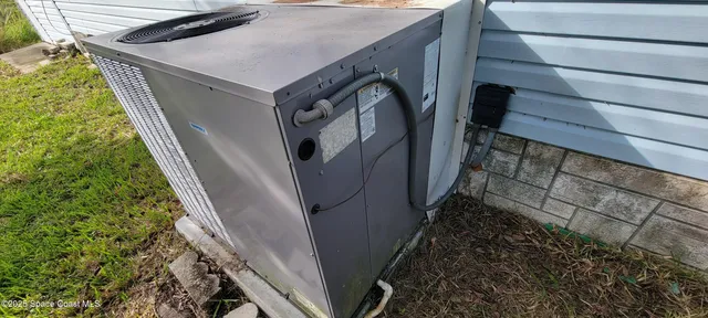 a view of a balcony with chairs and table in a patio