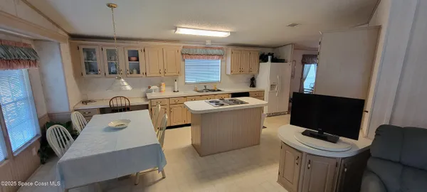 a room with furniture a flat screen tv and a window