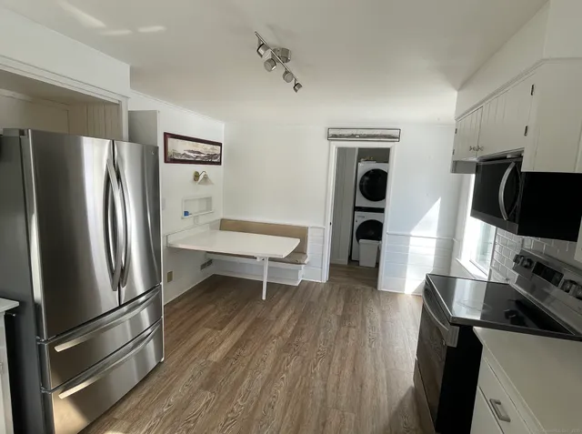 a kitchen with stainless steel appliances a refrigerator stove and microwave