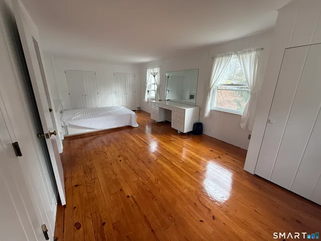 a view of a room with wooden floor and staircase