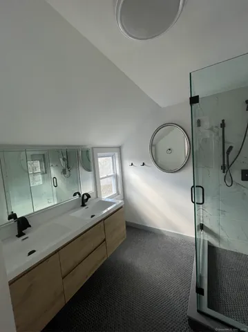 a bathroom with a sink mirror and vanity