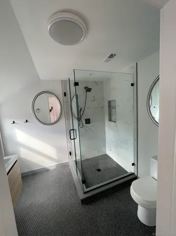 a bathroom with a toilet a sink and mirror
