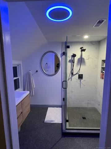 a bathroom with a mirror and a shower