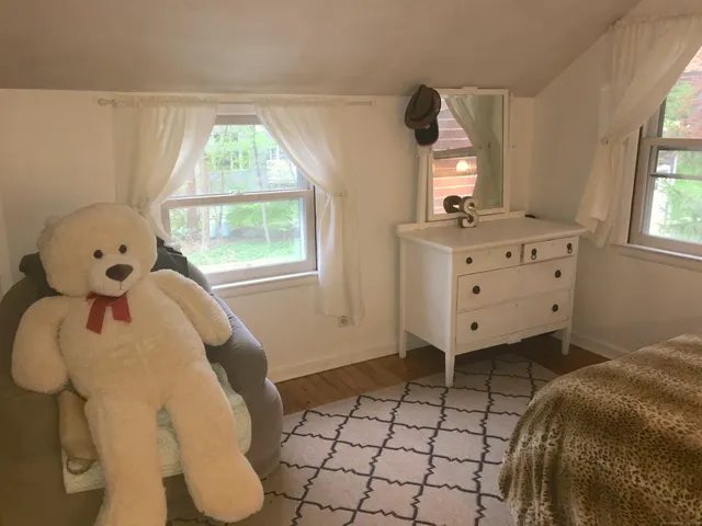 a bedroom with a bed and window