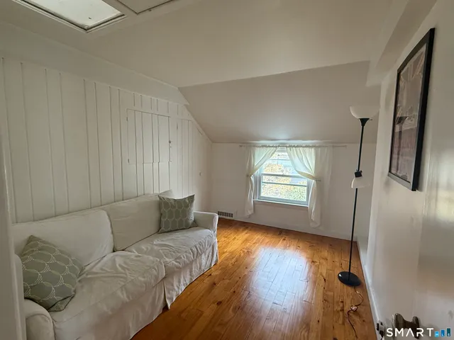 a living room with furniture and a hard wood floor